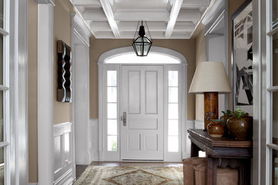 Inspiration for a mid-sized timeless dark wood floor entryway remodel in Chicago with beige walls and a white front door