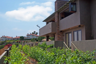 Inspiration for a large contemporary gray three-story concrete flat roof remodel in San Diego
