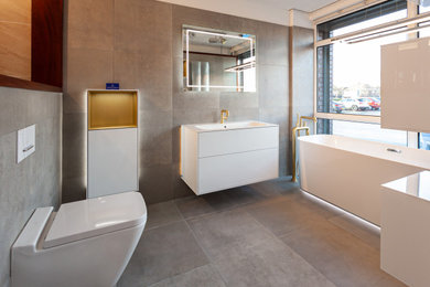 Inspiration for a modern bathroom in Manchester with white cabinets, a freestanding bath, white worktops, a single sink and a floating vanity unit.