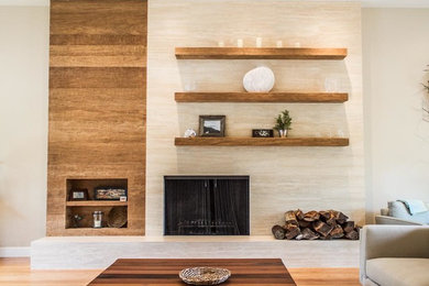 Minimalist formal and open concept medium tone wood floor and beige floor living room photo in San Francisco with beige walls, a standard fireplace, a stone fireplace and no tv