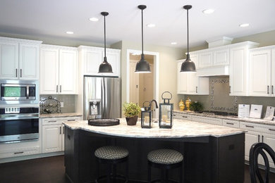 Inspiration for a large transitional l-shaped eat-in kitchen in Grand Rapids with an undermount sink, raised-panel cabinets, granite benchtops, grey splashback, subway tile splashback, stainless steel appliances, dark hardwood floors, with island and white cabinets.