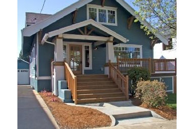 Example of an arts and crafts blue three-story wood exterior home design in Portland