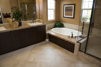 Drop-in bathtub - mid-sized contemporary master beige tile and stone tile drop-in bathtub idea in Other with open cabinets, light wood cabinets, granite countertops and brown countertops
