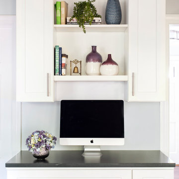 White cabinets black countertop create a perfect kitchen desk