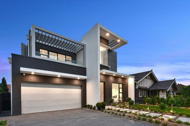 Photo of a mid-sized contemporary two-storey concrete grey house exterior in Sydney with a flat roof and a metal roof.