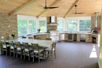 Large elegant l-shaped dark wood floor and brown floor open concept kitchen photo in DC Metro with a drop-in sink, flat-panel cabinets, stainless steel cabinets, granite countertops, brown backsplash, stone slab backsplash, stainless steel appliances and a peninsula