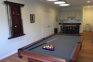 Mid-sized walk-out vinyl floor basement photo in Other with white walls