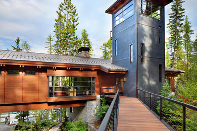 Huge modern brown three-story mixed siding exterior home idea in Other