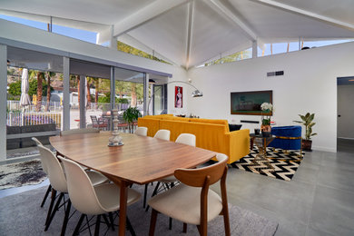 Example of a mid-century modern dining room design in Other