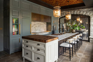 Enclosed kitchen - huge french country single-wall limestone floor, gray floor and wallpaper ceiling enclosed kitchen idea in Minneapolis with an undermount sink, recessed-panel cabinets, gray cabinets, marble countertops, beige backsplash, stone slab backsplash, paneled appliances, an island and beige countertops