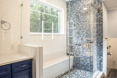Beach style white tile gray floor and single-sink bathroom photo in Manchester with blue cabinets and white countertops