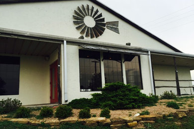 Inspiration for a large timeless white one-story stucco gable roof remodel in Dallas