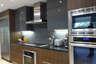 Inspiration for a large contemporary beige floor open concept kitchen remodel in Miami with flat-panel cabinets, dark wood cabinets, an island, quartzite countertops and stainless steel appliances