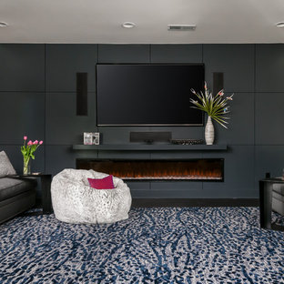 Design ideas for an expansive modern look-out basement with dark hardwood flooring, brown floors, grey walls, a ribbon fireplace and a wooden fireplace surround.