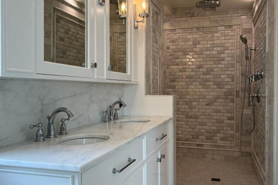 Example of a master white tile and marble tile marble floor, white floor and double-sink bathroom design in New York with glass-front cabinets, white cabinets, white walls, marble countertops, white countertops and a floating vanity