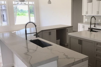Kitchen - large contemporary light wood floor and brown floor kitchen idea in Toronto with an undermount sink, shaker cabinets, white cabinets and two islands