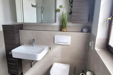 Kleines Modernes Badezimmer mit dunklen Holzschränken, bodengleicher Dusche, Wandtoilette mit Spülkasten, beigen Fliesen, weißer Wandfarbe, Porzellan-Bodenfliesen, Wandwaschbecken, braunem Boden, Einzelwaschbecken, schwebendem Waschtisch und Holzdielendecke in Frankfurt am Main