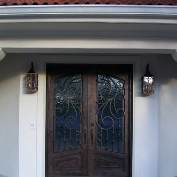 Entry Iron Door with Iron Wall Sconces