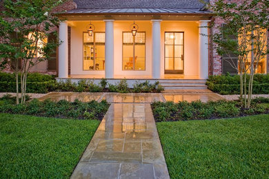 Inspiration for a mid-sized traditional front yard full sun garden for fall in Houston with a garden path and concrete pavers.