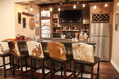 Seated home bar - large rustic galley vinyl floor and brown floor seated home bar idea in Milwaukee with an undermount sink, shaker cabinets, gray cabinets, granite countertops and stone slab backsplash