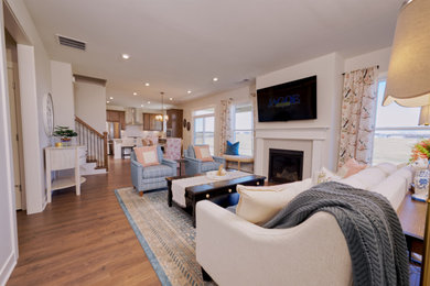 Large minimalist open concept medium tone wood floor and brown floor living room photo in Louisville with a standard fireplace, white walls, a metal fireplace and a wall-mounted tv