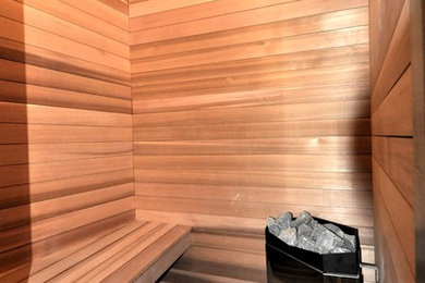 Large transitional master brown tile, gray tile and ceramic tile medium tone wood floor and beige floor bathroom photo in Boston with flat-panel cabinets, dark wood cabinets, a two-piece toilet, beige walls and a vessel sink