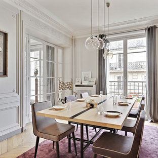 Réalisation d'une salle à manger design fermée avec un mur gris, un sol en bois clair et un sol beige.