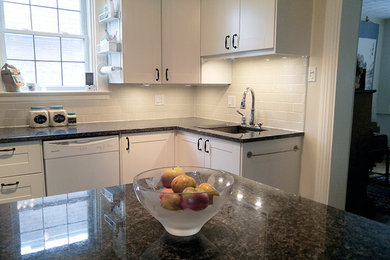 Small transitional l-shaped ceramic tile enclosed kitchen photo in Ottawa with an undermount sink, recessed-panel cabinets, white cabinets, granite countertops, gray backsplash, subway tile backsplash, stainless steel appliances and a peninsula