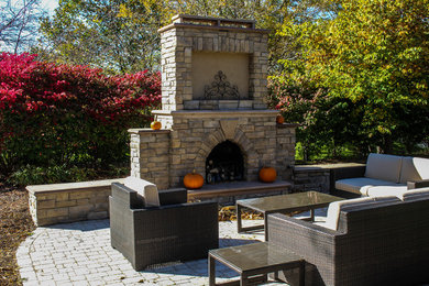 Example of a patio design in Omaha with a fire pit