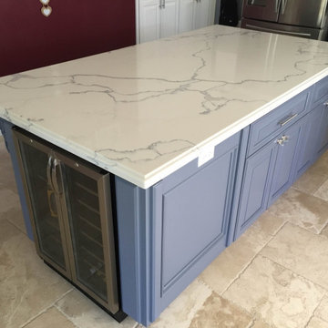 Kitchen blue cabinets island with Calacatta Gold Quartz countertops