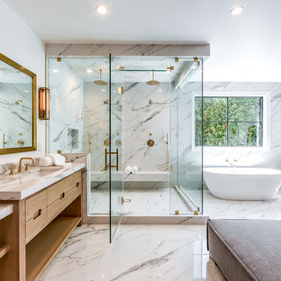 На фото: ванная комната в стиле современная классика с плоскими фасадами, фасадами цвета светлого дерева, отдельно стоящей ванной, двойным душем, белыми стенами, душевой кабиной, врезной раковиной, душем с распашными дверями и серой столешницей с