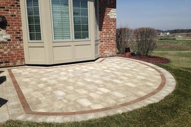 Backyard brick patio photo in Chicago with no cover