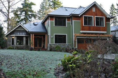 Large transitional multicolored two-story mixed siding house exterior photo in Seattle with a hip roof and a shingle roof