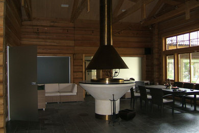 Источник вдохновения для домашнего уюта: открытая гостиная комната среднего размера с коричневыми стенами, полом из керамогранита, подвесным камином и черным полом