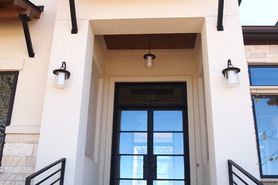 Example of a mid-sized trendy white two-story stucco exterior home design in Austin with a shingle roof