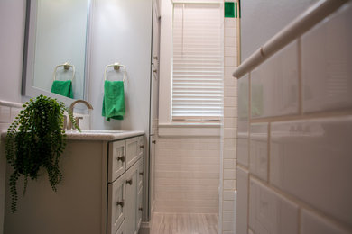 Example of a mid-sized white tile ceramic tile and single-sink bathroom design in Other with gray cabinets, quartzite countertops, white countertops and a niche