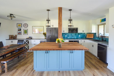 Example of a small beach style l-shaped vinyl floor and brown floor eat-in kitchen design in Santa Barbara with an undermount sink, shaker cabinets, white cabinets, quartzite countertops, blue backsplash, ceramic backsplash, stainless steel appliances, an island and gray countertops