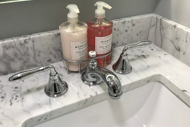 Example of a transitional bathroom design in Bridgeport with an undermount sink and marble countertops