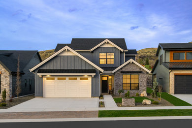 Mid-sized transitional blue two-story house exterior idea in Boise with a shingle roof and a black roof