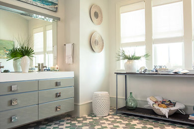 Example of a large beach style master mosaic tile floor and multicolored floor bathroom design in Miami with flat-panel cabinets, gray cabinets, white walls, a two-piece toilet, an undermount sink and quartzite countertops