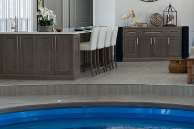 Example of a huge beach style stamped concrete pool design in Toronto