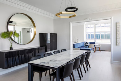 Dining room - contemporary light wood floor and beige floor dining room idea in New York with gray walls