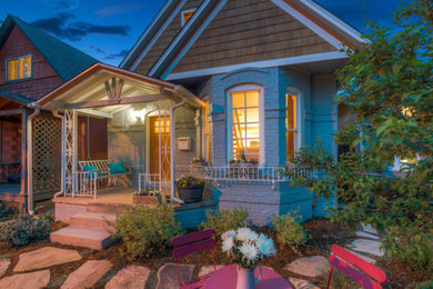 Photo of a small victorian drought-tolerant front yard stone retaining wall landscape in Denver.
