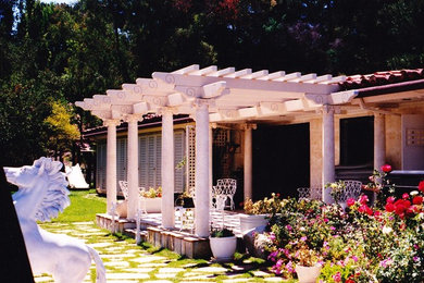 Example of a mid-sized transitional backyard patio design in San Francisco with a pergola