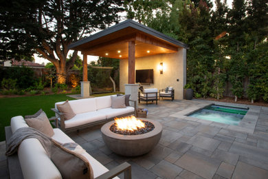 Trendy backyard concrete paver patio photo in San Francisco with a fire pit and a gazebo