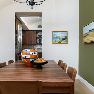 Contemporary Dining Room with Walnut Table and Accent Wall in San Diego