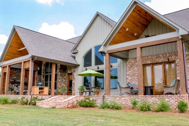 Patio - rustic backyard brick patio idea in Jackson with a roof extension
