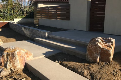 Example of a mid-sized minimalist beige one-story stucco flat roof design in San Diego