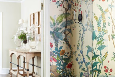 Entryway - large eclectic dark wood floor entryway idea in New York with multicolored walls and a white front door