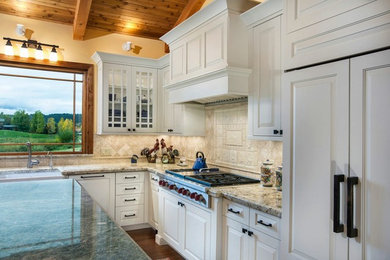 Inspiration for a large timeless l-shaped dark wood floor eat-in kitchen remodel in Denver with white cabinets, an island, a farmhouse sink, raised-panel cabinets, beige backsplash, ceramic backsplash and white appliances